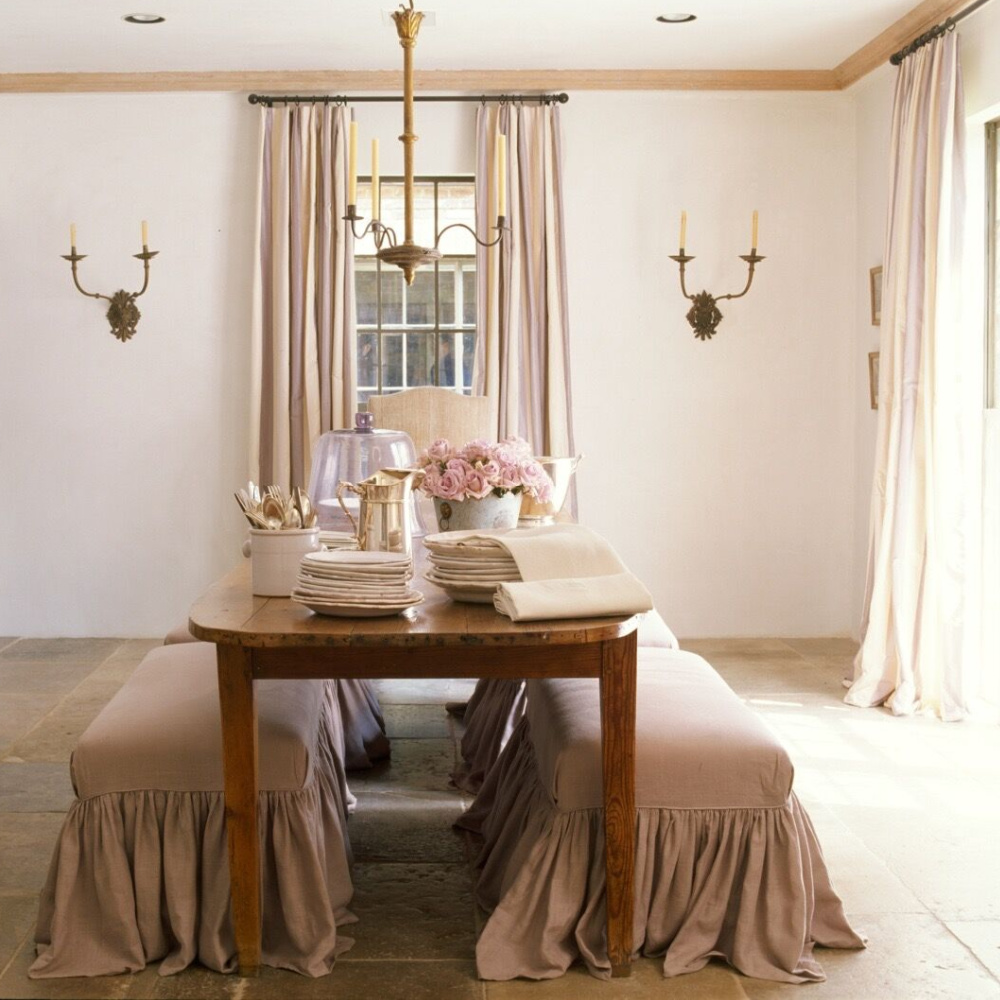 Ruth Gay's gorgeous rosy dining room with Old World French elegance. Chateau Domingue Timeless European Elegance and French farmhouse style converge in this house tour of founder Ruth Gay's home on Hello Lovely. Reclaimed stone, antique doors and mantels, and one of a kind architectural elements. #housetour #frenchcountry #frenchfarmhouse #europeanfarmhouse #chateaudomingue #rusticdecor #pamelapierce #elegantdecor #diningroom #romantic