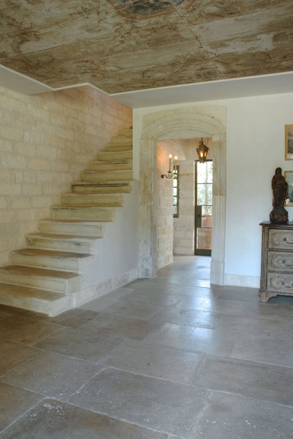 Chateau Domingue - Ruth Gay's exquisite French home with reclaimed materials from Europe features stone staircase and wood planked ceilings.