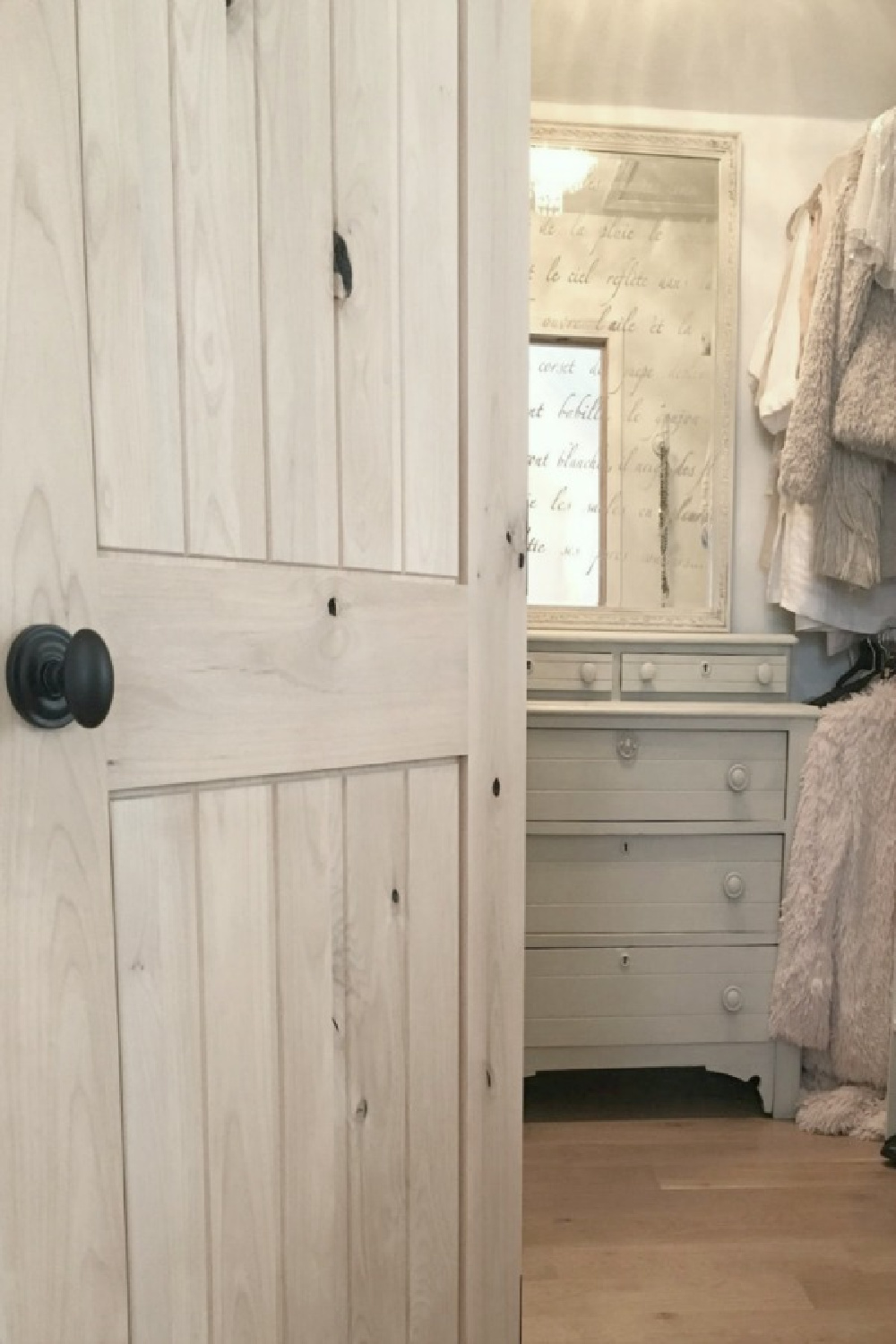 Rustic knotty alder door to my closet with antique painted dresser and stenciled mirror - Hello Lovely Studio.