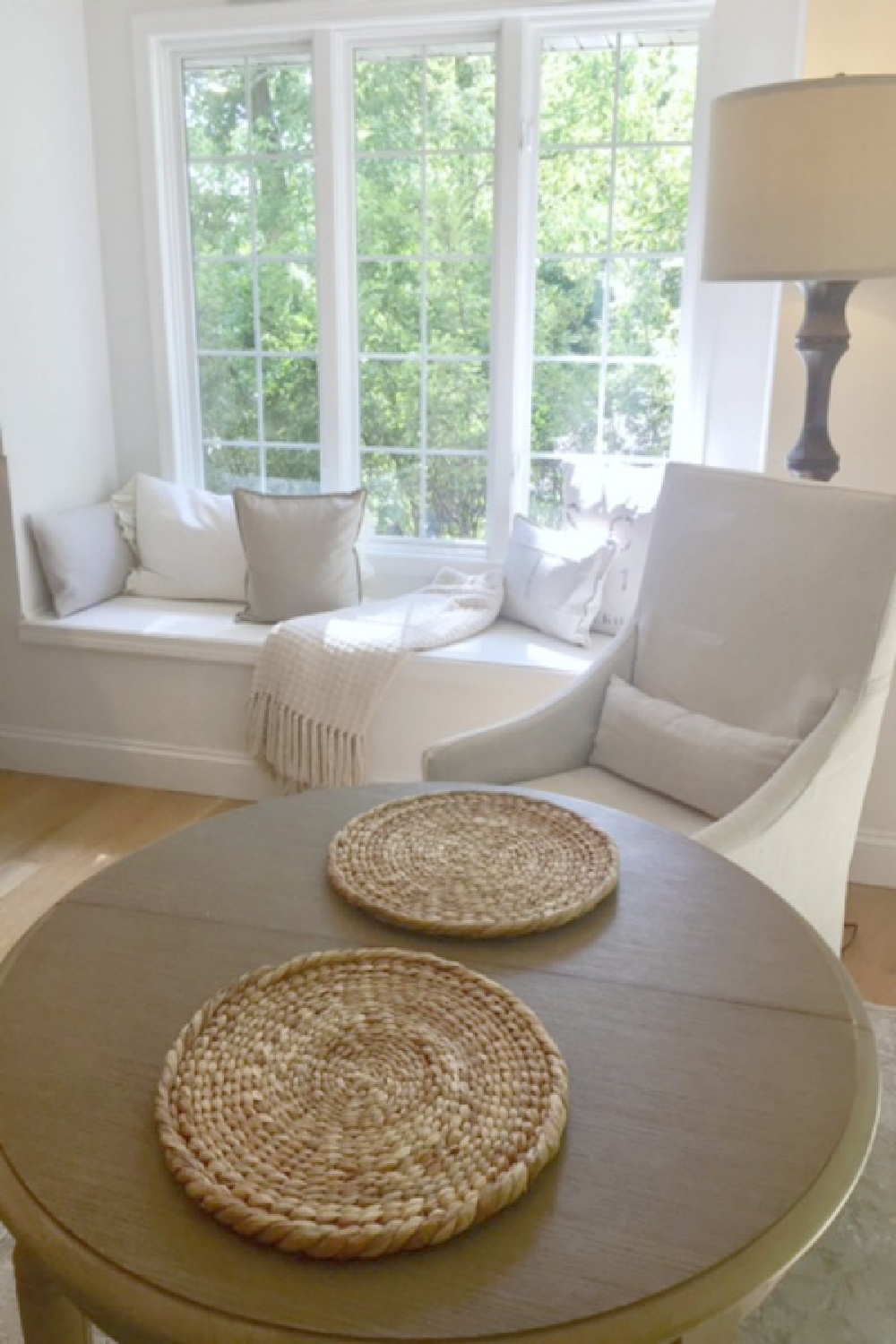 Window seat with grainsack pillows and Belgian linen slope arm dining chair in breakfast nook - Hello Lovely.