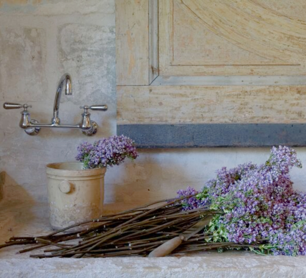 Pale tones of rugged stone, antiques, earthenware, and age sing with French lavender in Ruth Gay's Old World Houston home - Chateau Domingue.