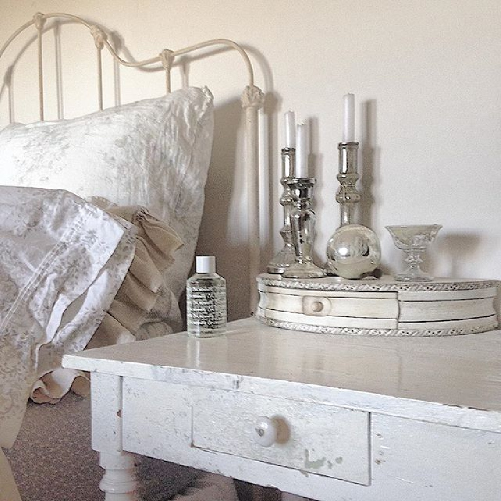 Charming and rustic white Scandi bedroom with iron vintage bed and country wood night table - My Petite Maison.