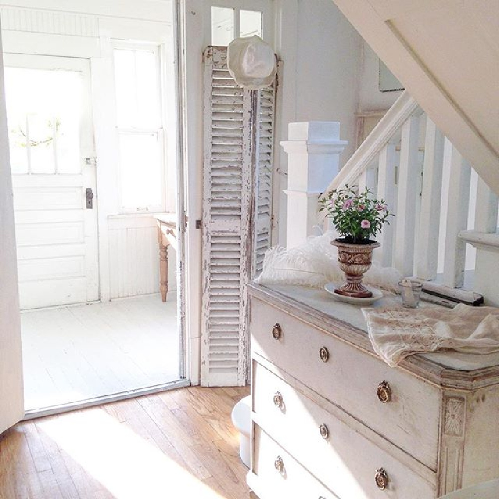 All white French Nordic cottage entry with Swedish antiques, rustic shutters, and white painted floors - My Petite Maison.