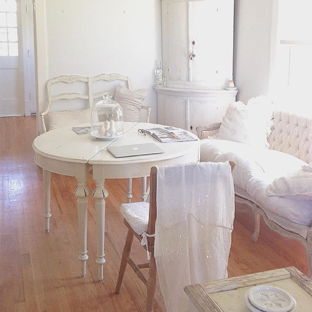 White painted rounded antique Swedish corner cabinet and French Nordic charm in a living room - My Petite Maison.