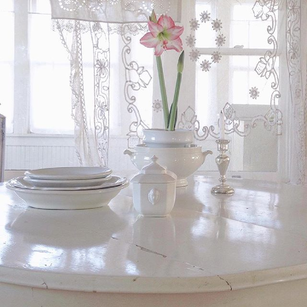 Vintage French ironstone, all white decor, and sheer lace curtain panels in a serene Nordic French cottage by MyPetiteMaison.