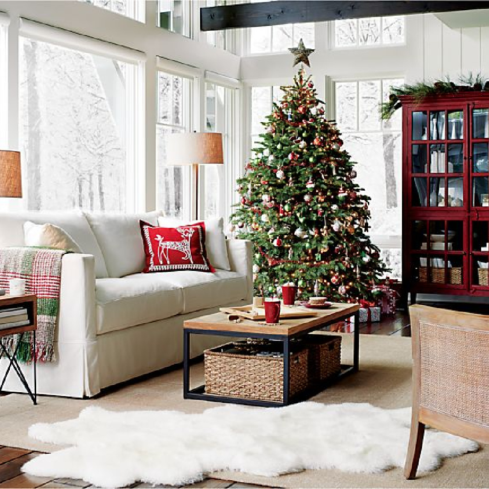 Family room decorated for Christmas with tree, garland, and Willow modern slipcovered sofa - Crate & Barrel. #holidaydecor #familyroom