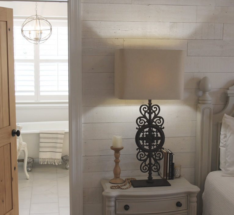 French country Nordic bedroom with Stikwood Hamptons wallcovering and bathroom with clawfoot tub. #hellolovelystudio #mastersuite #frenchcountry #frenchnordic #stikwood #hamptons #cottagestyle #bedroomdecor #clawfoottub