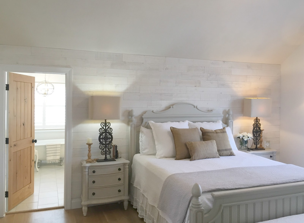 French country Nordic bedroom with Stikwood Hamptons wallcovering and bathroom with clawfoot tub. #hellolovelystudio #mastersuite #frenchcountry #frenchnordic #stikwood #hamptons #cottagestyle #bedroomdecor #clawfoottub