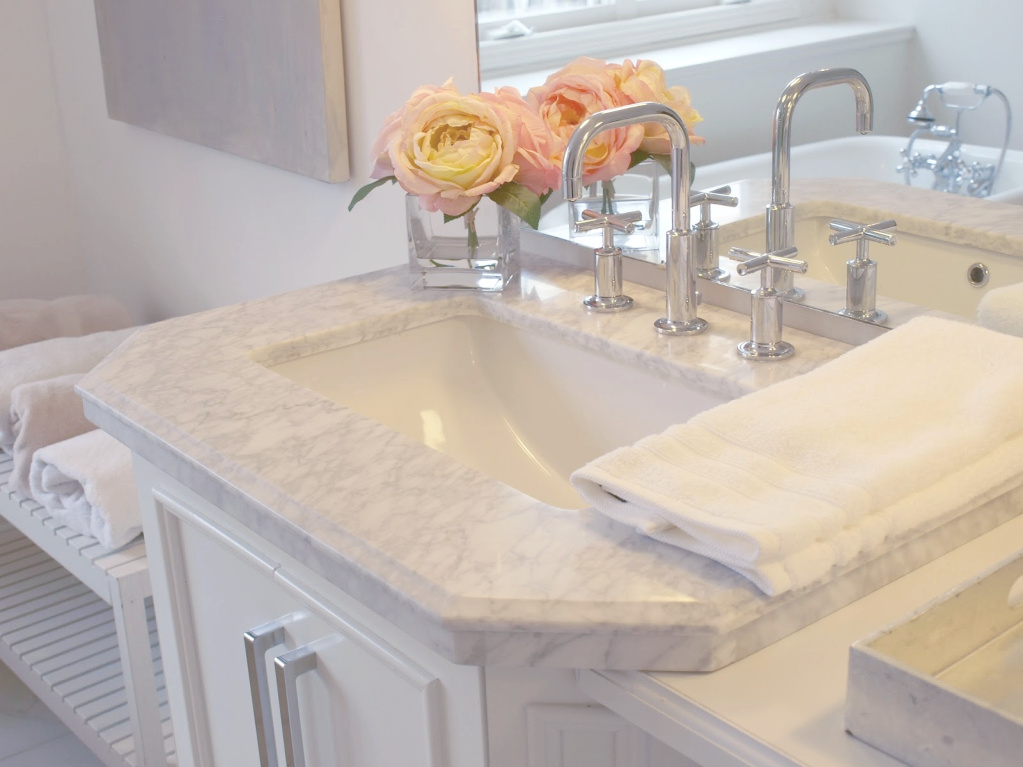 Traditional freestanding white single vanity with carrara marble top in our French country bathroom. #hellolovelystudio #bathroomdesign #whitevanity #carraramarble #kohlerpurist #bathroomfaucets