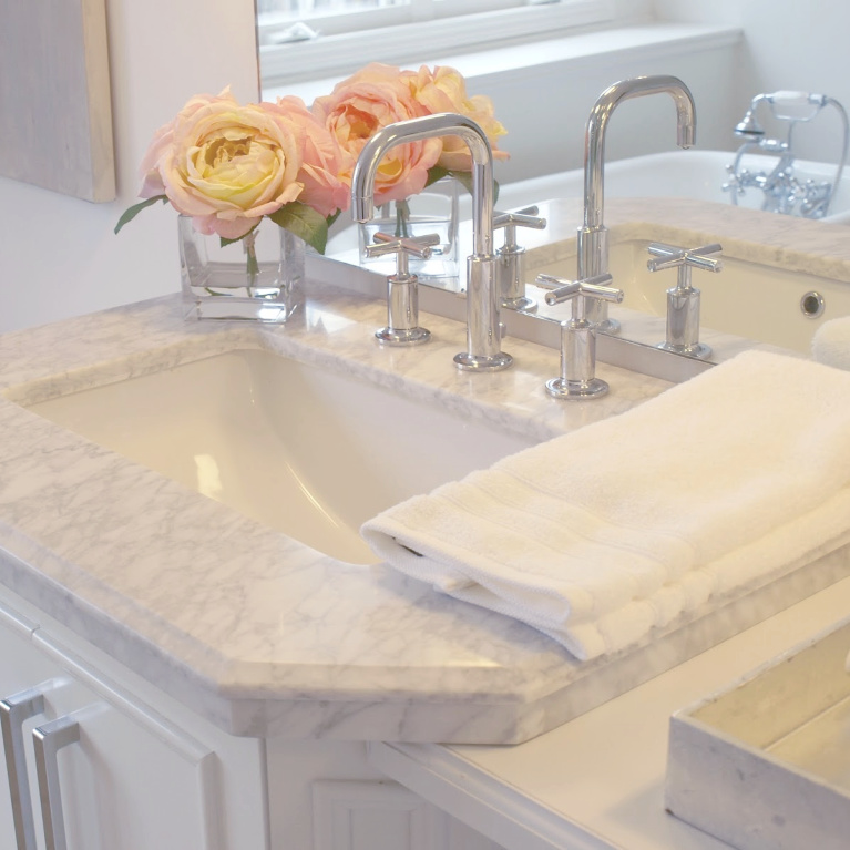 Traditional freestanding white single vanity with carrara marble top in our French country bathroom. #hellolovelystudio #bathroomdesign #whitevanity #carraramarble #kohlerpurist #bathroomfaucets