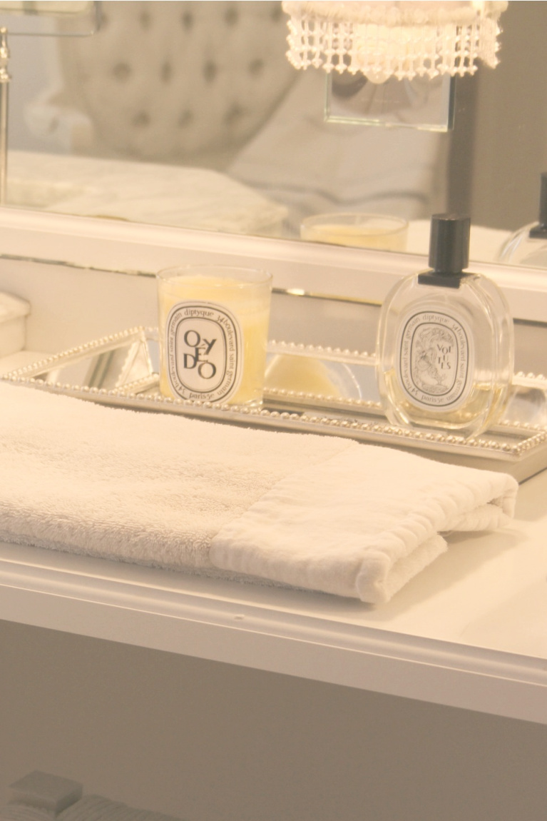 Diptyque on a mirrored tray on my makeup counter - Hello Lovely Studio.