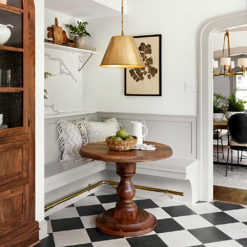Scrivano kitchen's breakfast nook with banquette, checkered floor and custom wood table. Fixer Upper on HGTV.