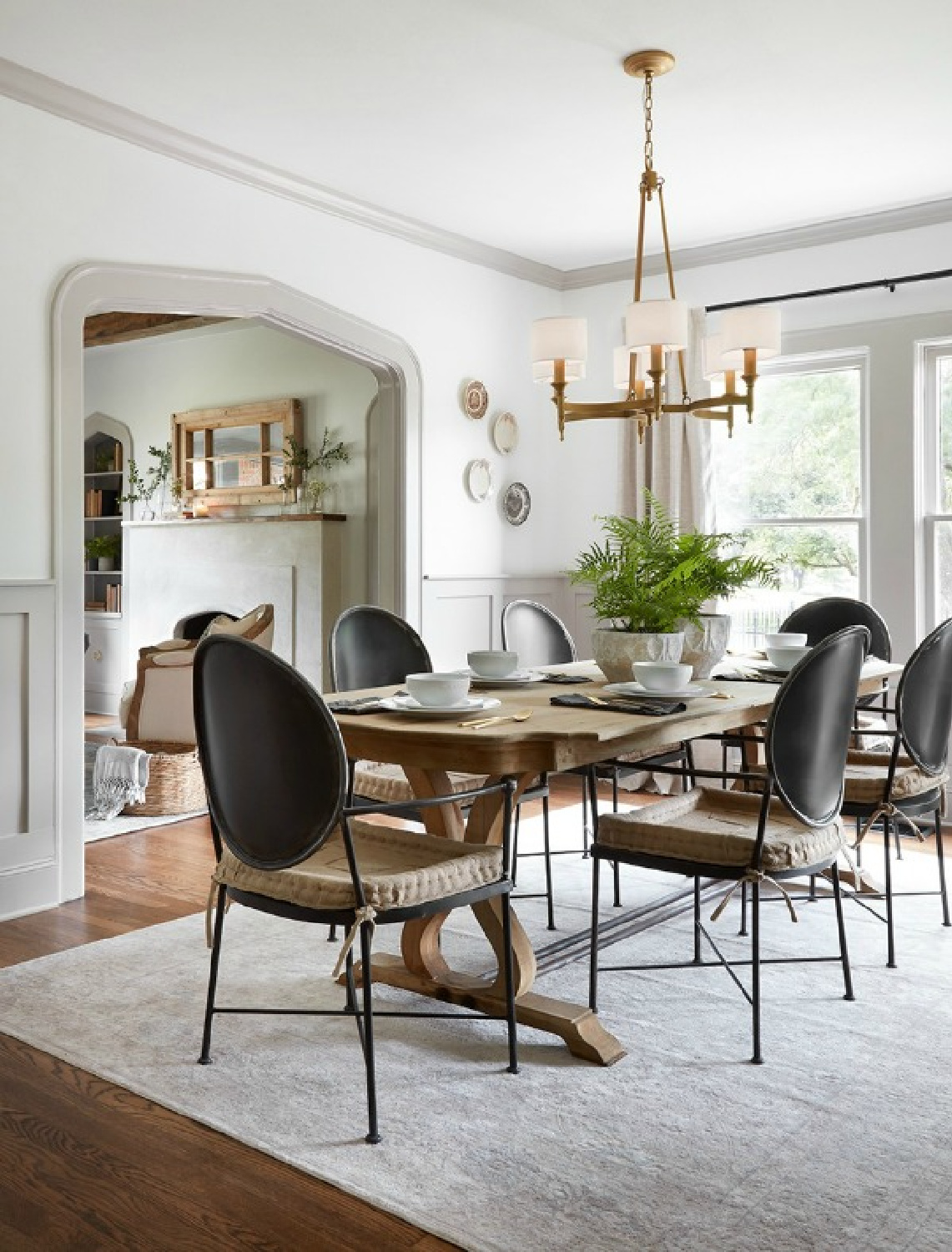 Scrivano dining room: modern Louis style black dining chairs,, grey trim, white walls, neutral classic style. Come get the Look of the Scrivano Tudor renovated by Joanna & Chip on HGTV's FIXER UPPER! #scrivano #fixerupper #diningroom