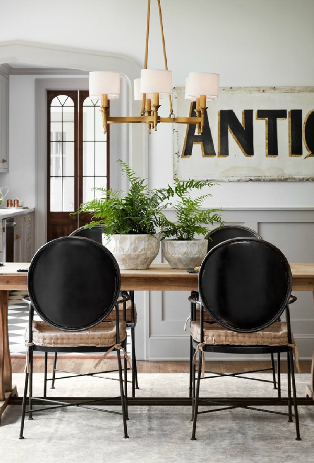 Get the Look: Scrivano FIXER UPPER Cottage Decor! This charming vintage style dining room has modernized Louis chairs and a tranquil palette. #scrivano #fixerupper #diningroom #interiordesign #greytrim #serenedecor