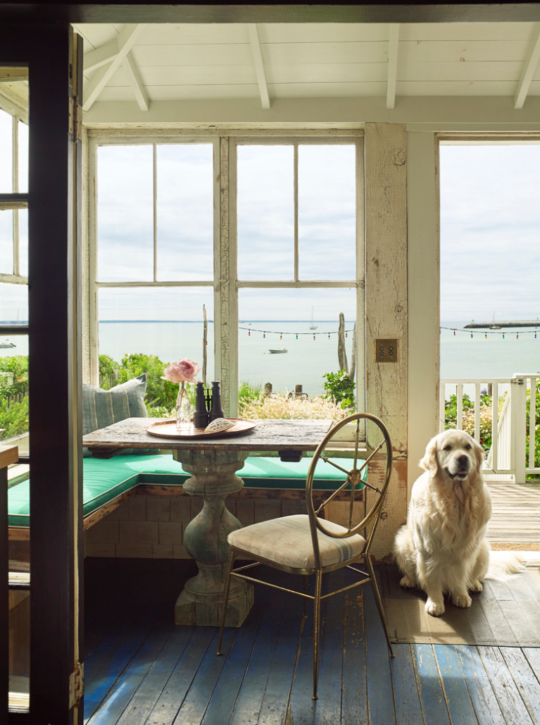 Ken Fulk's charming seaside cottage porch in Provincetown - photo by Tria Giovan for Jennifer Rudick's SUMMER TO SUMMER. #cottagestyle #seasidecottage #porch #newengland #interiordesign #kenfulk #goldenretriever #englishcream