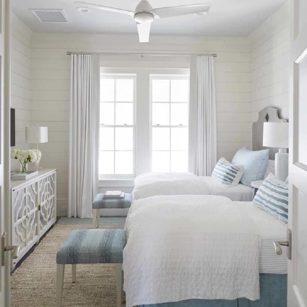 Breezy and chic coastal bedroom with blue accents and ottoman bed benches - architecture: Geoff Chick.