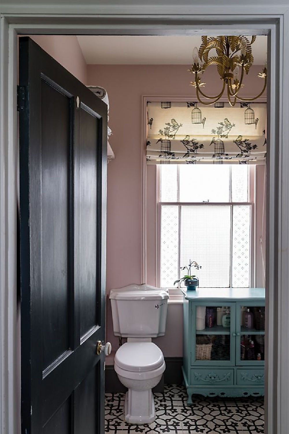 Calamine No.230 Farrow & Ball in a bathroom with freestanding teal cupboard with glass doors.