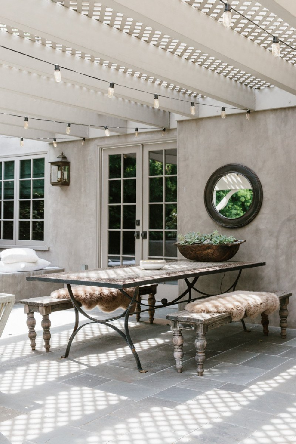 Erin Fetherston outdoor dining area with rustic benches and pergola. Come explore California modern farmhouse style and score ideas to get the look!