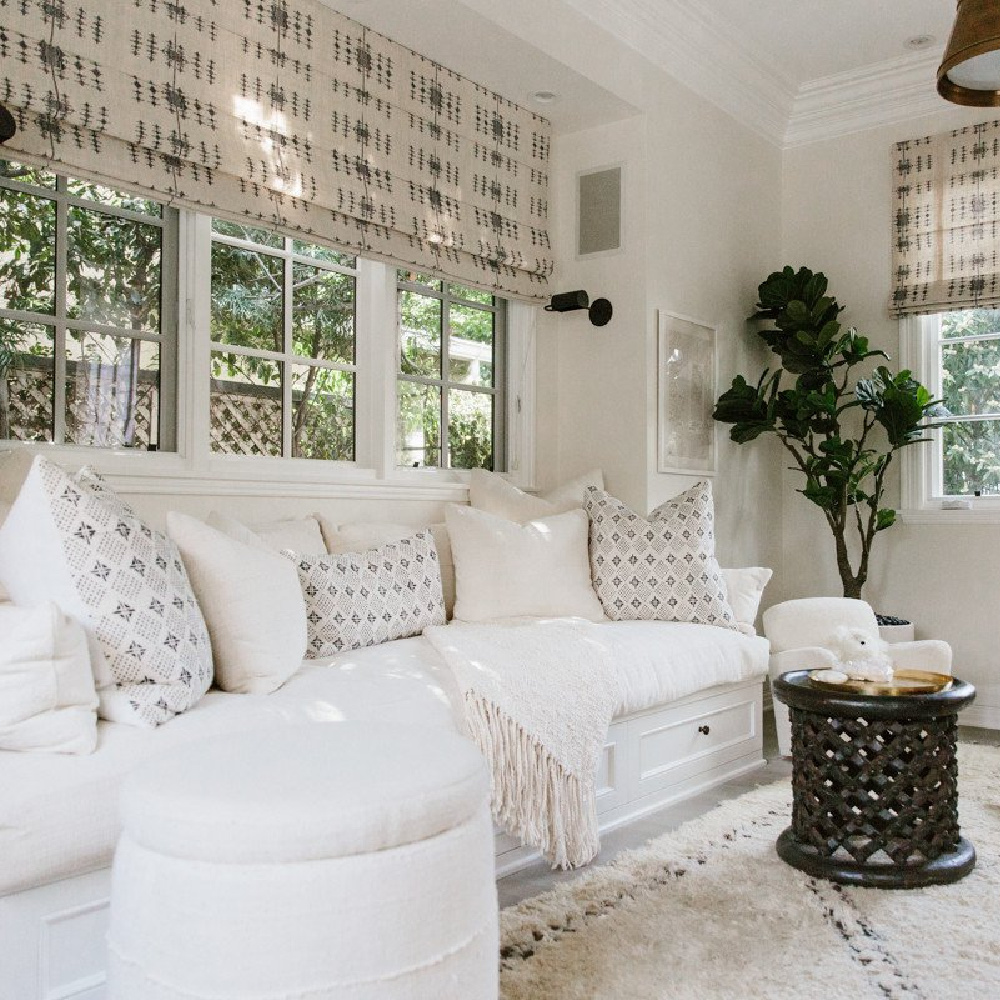 White on white neutral interior design in a den with white sofa - Erin Fetherston.