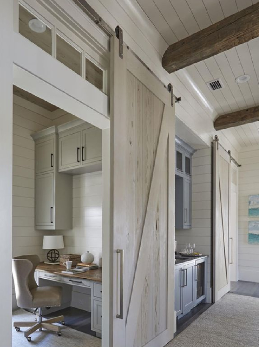 Home office with barn door, transom, and shiplap in a classic coastal home with architecture by Geoff Chick & Associates. #homeoffice #shiplap #coastalstyle