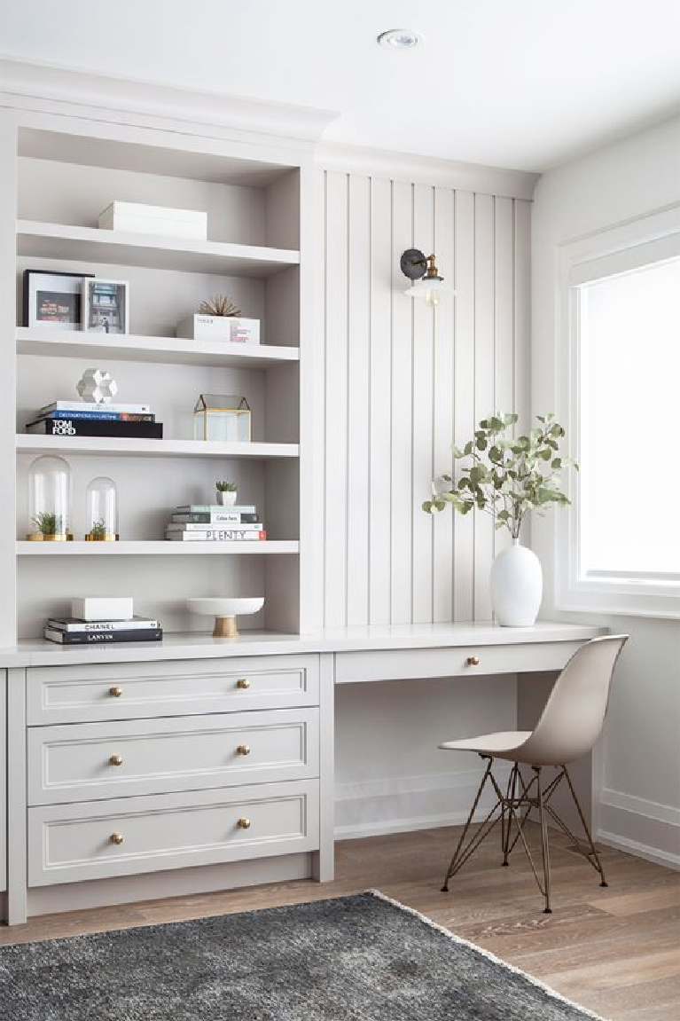 Beautiful grey painted custom millwork in the home office of a Toronto home - design by Collective Studio. #homeoffice #builtins #interiordesign #millwork #serenedesign