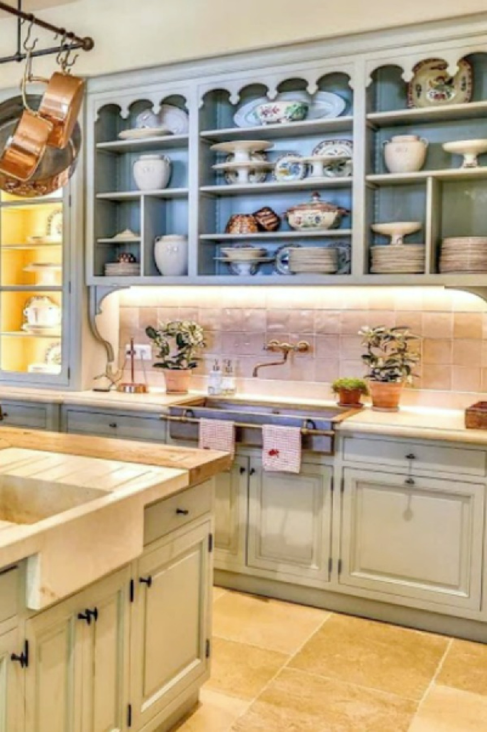 Light blue kitchen cabinets and zellige tile backsplash in a historic French farmhouse in Provence (Le Mas des Poiriers).