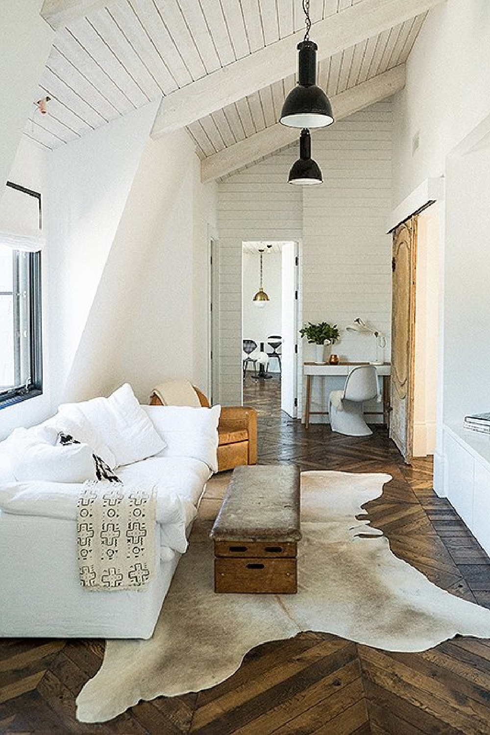 Leanne Ford designed modern rustic interior design with white sofa, white walls and black accents.