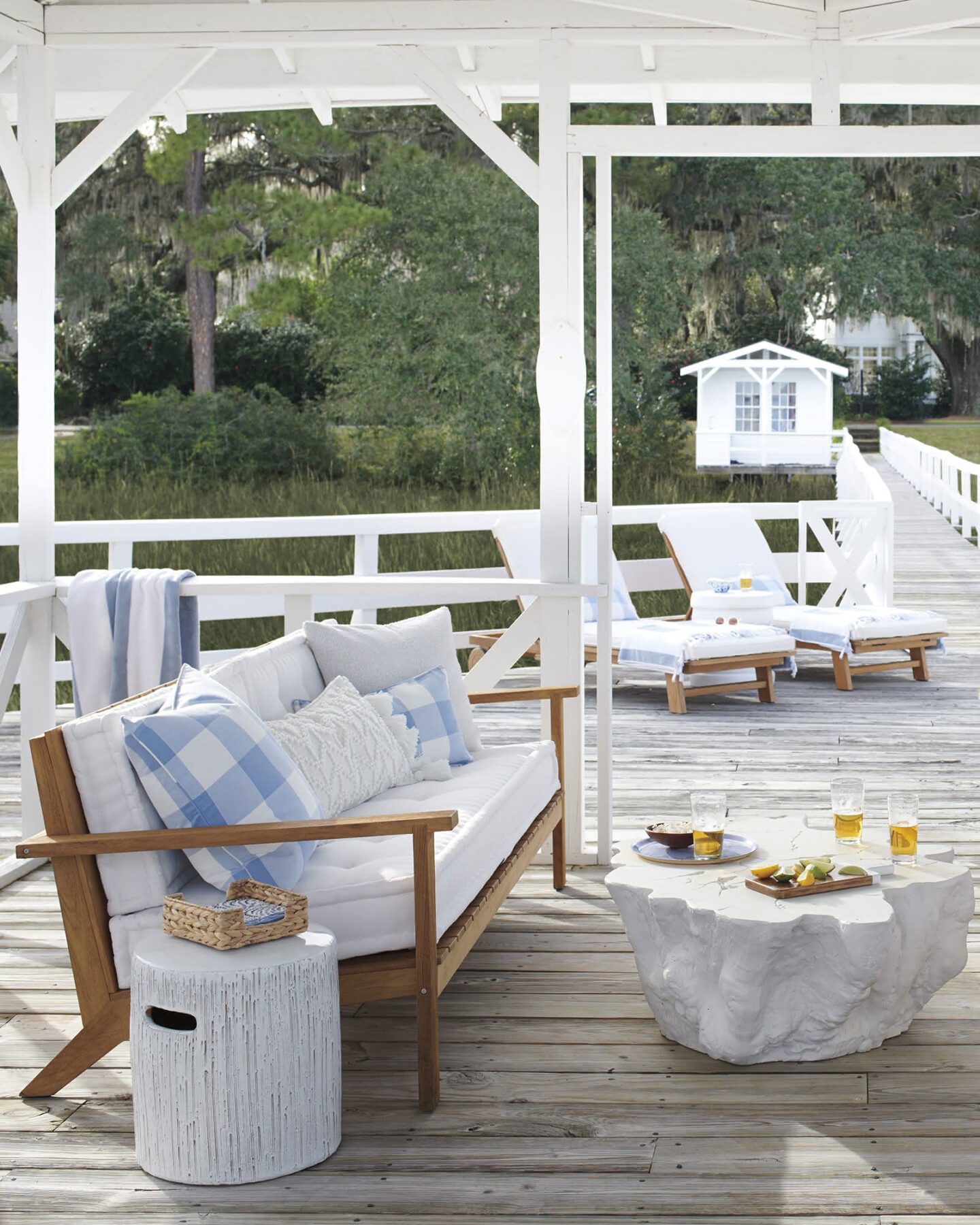 Coastal design inspiration on this porch with Serena & Lily blue check pillows and furniture. #serenanadlily #coastalstyle #porchdecor #homedecor #furniture #summerliving #outdoorliving