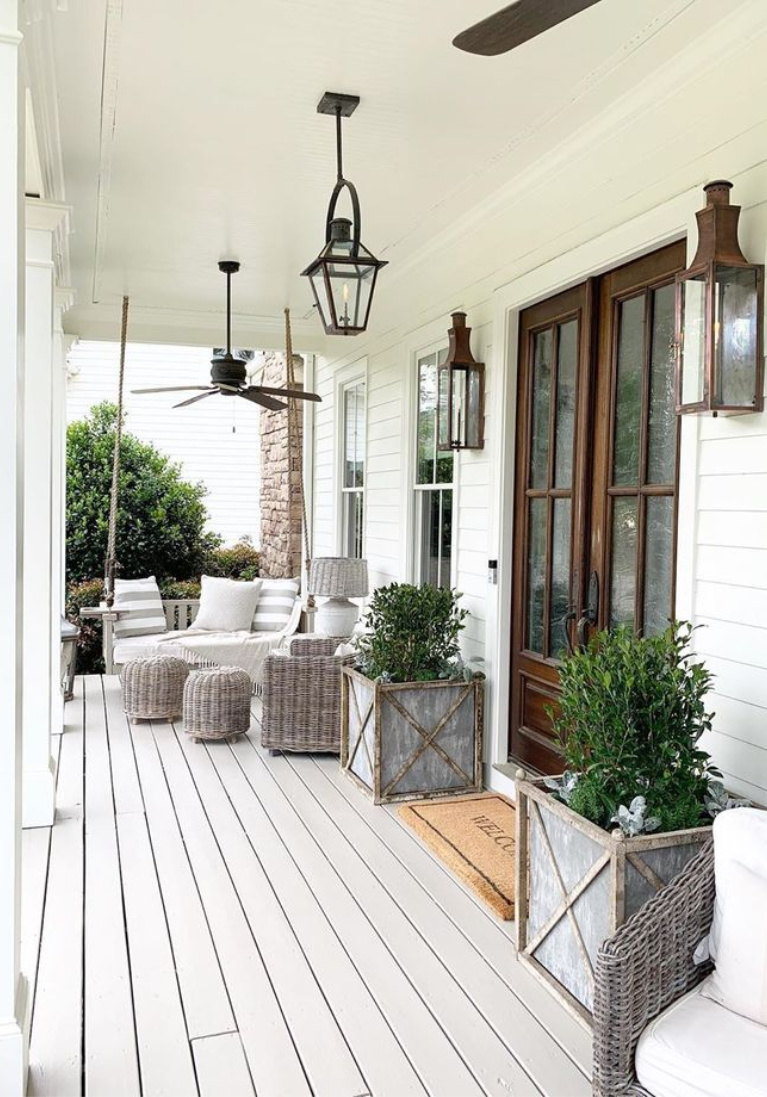 Beautiful Southern porch with Bevolo lanterns, ceiling fans, and outdoor furniture. Linen & Flax Co.Come peek at  Charming Porch Inspiration & Decor Ideas. #southernporch #porchdecor #summerliving #houseexteriors #porchlighting #forntporches