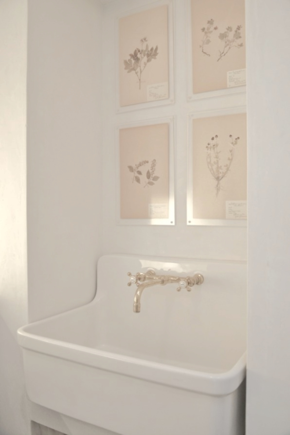 Kohler Gilford sink and botanical framed prints in Patina Farm laundry room - Brooke Giannetti of Velvet & Linen.