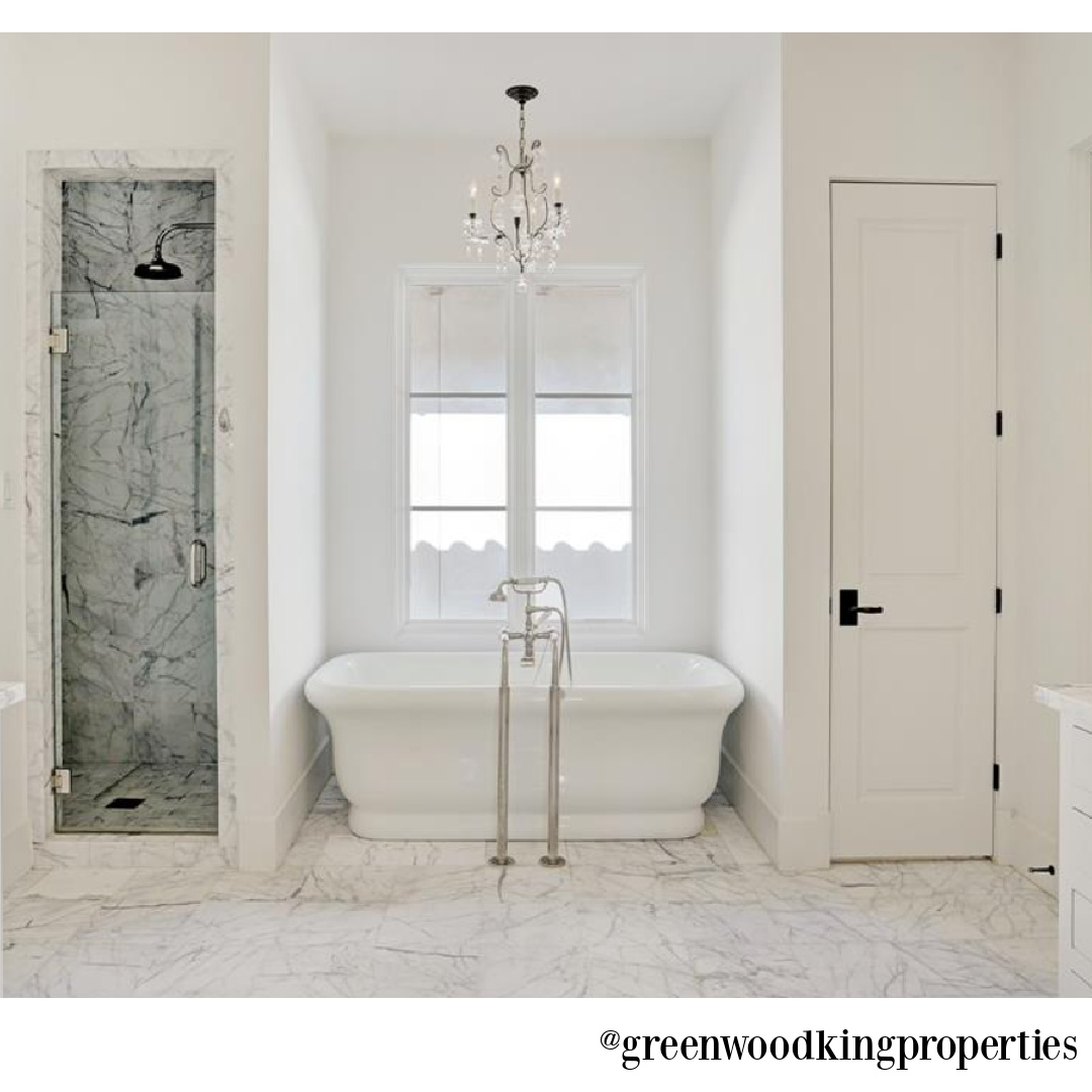 Soaker tub flanked by shower and closet in an elegant modern French Houston bath - @greenwoodkingproperties