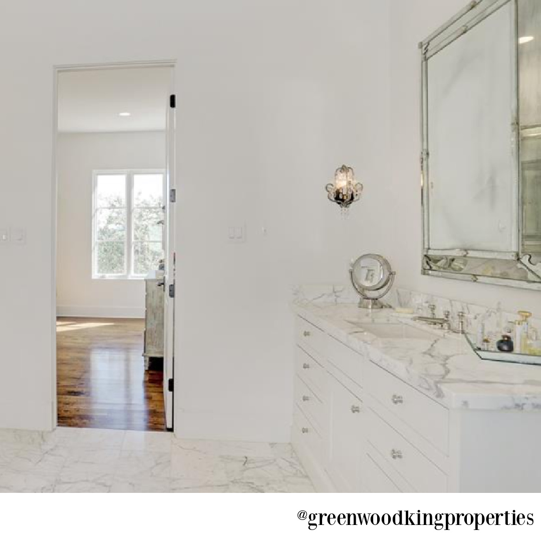 Elegant white marble bathroom in a Houston home with interiors by M Naeve - @greenwoodkingproperties