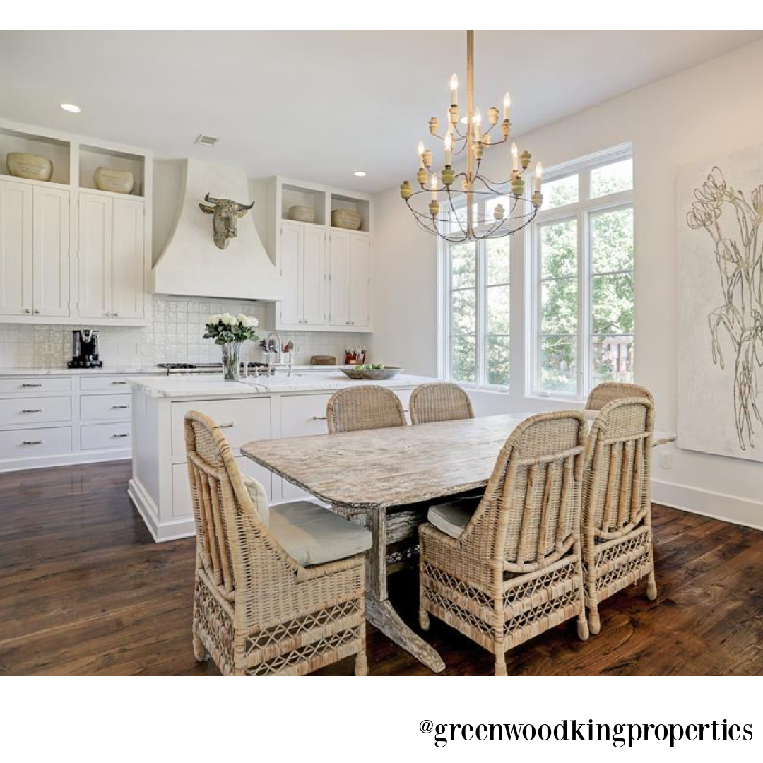 Modern French elegant white kitchen and dining area in a Houston home (115 Berthea) with interiors by M Naeve. #modernFrench #whitekitchens #frenchcountry