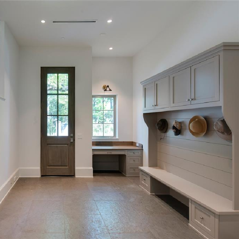 Mud room with 10' tall mahogany door in Stunning French inspired luxury home in Houston. #luxuryhome #frenchhome #frenchcountry #sophisticateddecor #timelessdesign