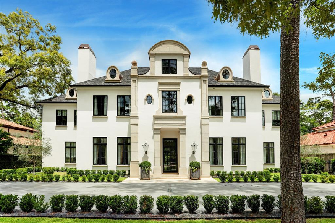 Stucco, cast stone, and limestone front facade of a magnificent European inspired Houston home by Charles W. Ligon. #houseexterior #luxuryhome #mansions #europeaninspired #houstonhome