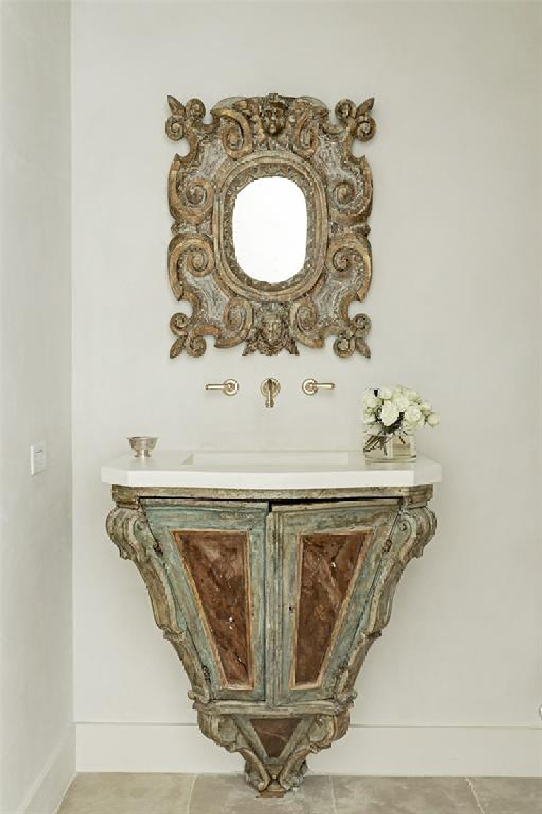 Segreto stone sink in antique Italian console and wall mounted brass faucet. #frenchcountry #bathroomdesign #segretostone #antiques #oldworldstyle #interiordesign