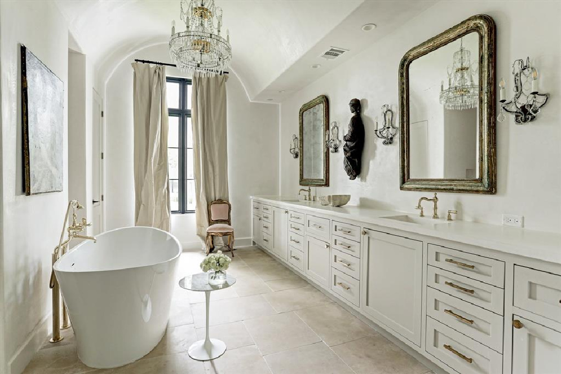 Luxurious French bathroom with soaking tub and sparkling chandelier. #bathroomdesign #frenchcountry #elegantdecor #luxuryhome #interiordesign