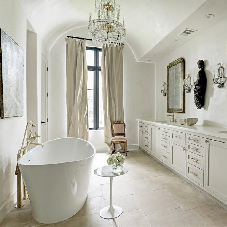 Luxurious French bathroom with soaking tub and sparkling chandelier. #bathroomdesign #frenchcountry #elegantdecor #luxuryhome #interiordesign