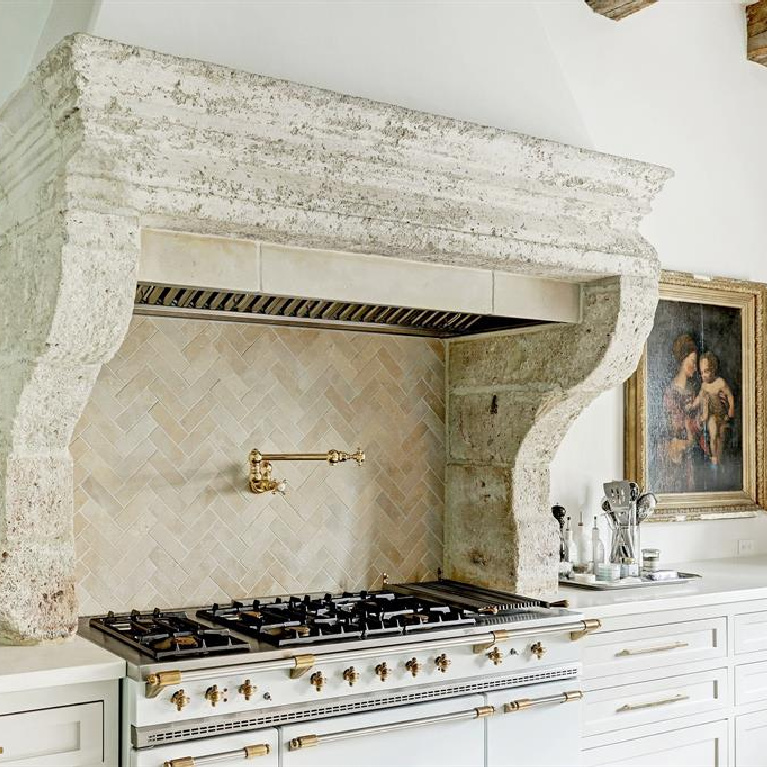 16th century stone mantel above Lacanche range in stunning Houston kitchen with Segreto stone countertop. #frenchkitchens #frenchmantel #oldworldstyle #frenchcountry #chateaudomingue #bespokekitchen #timelessdesign