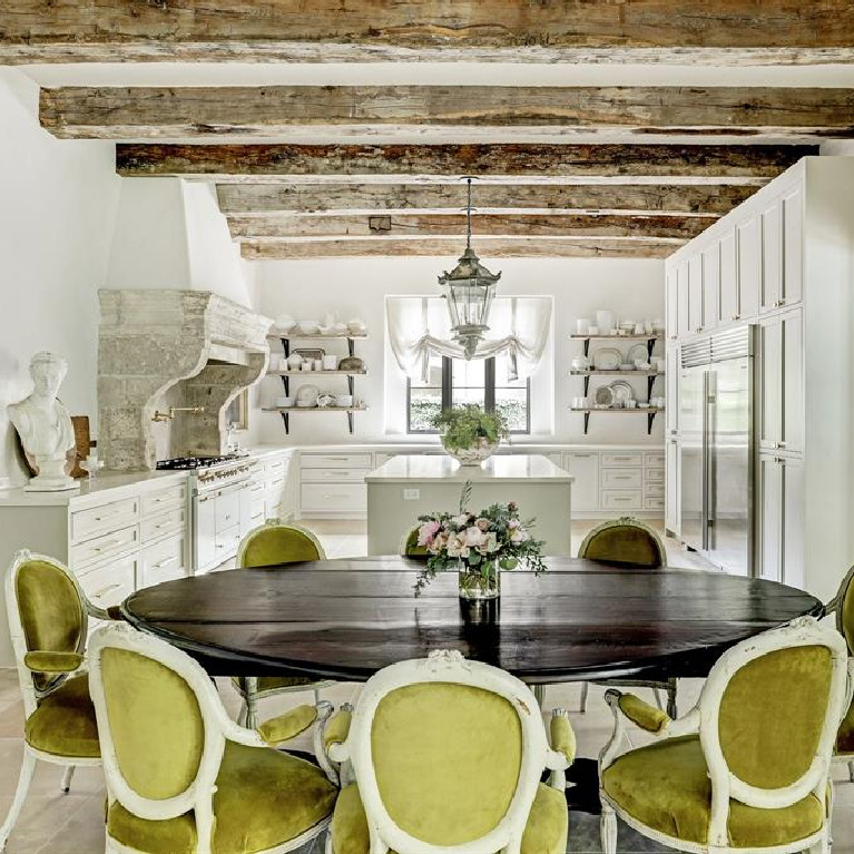 Rustic wood beams and antique street lights from Barcelona in Pale and serene French interiors in a luxurious Houston home built with authentic European materials and bespoke finishes. #timelessdesign #interiordesign #frenchcountry #europeancountry #antiques #oldworldstyle #modernfrench #frenchkitchen