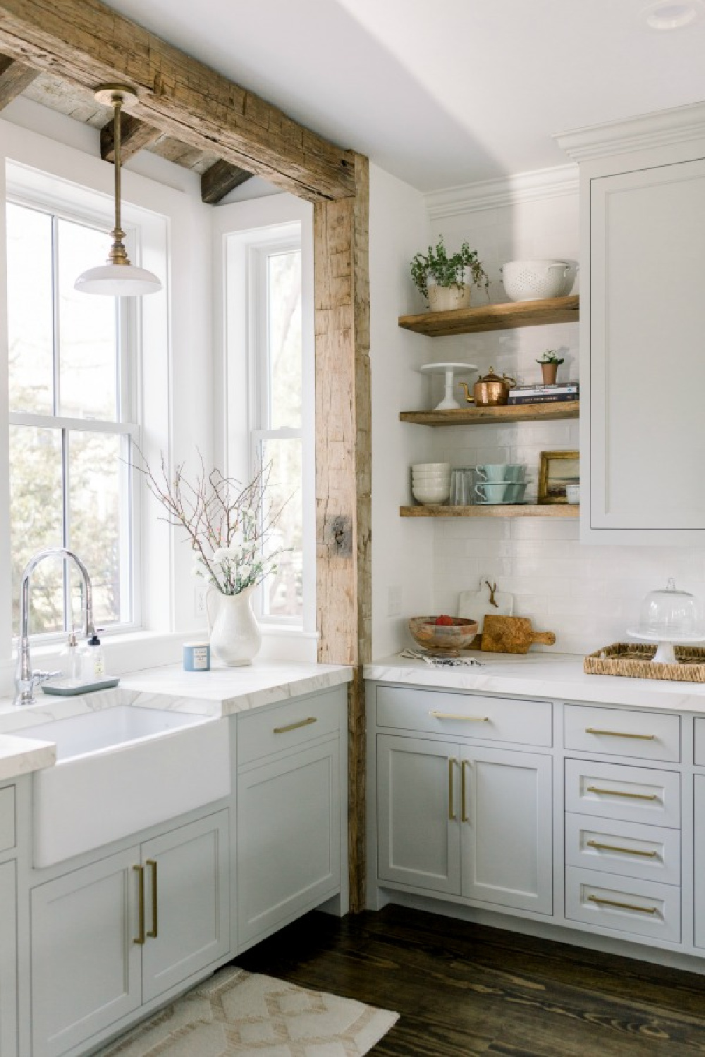 Elegant white farmhouse kitchen with Benjamin Moore Repose Grey cabinets, subway tile, gold accents, and reclaimed barn wood. Design: Finding Lovely.  See more Gorgeous European Country Interior Design Inspiration on Hello Lovely. #europeancountry #frenchfarmhouse #interiordesign