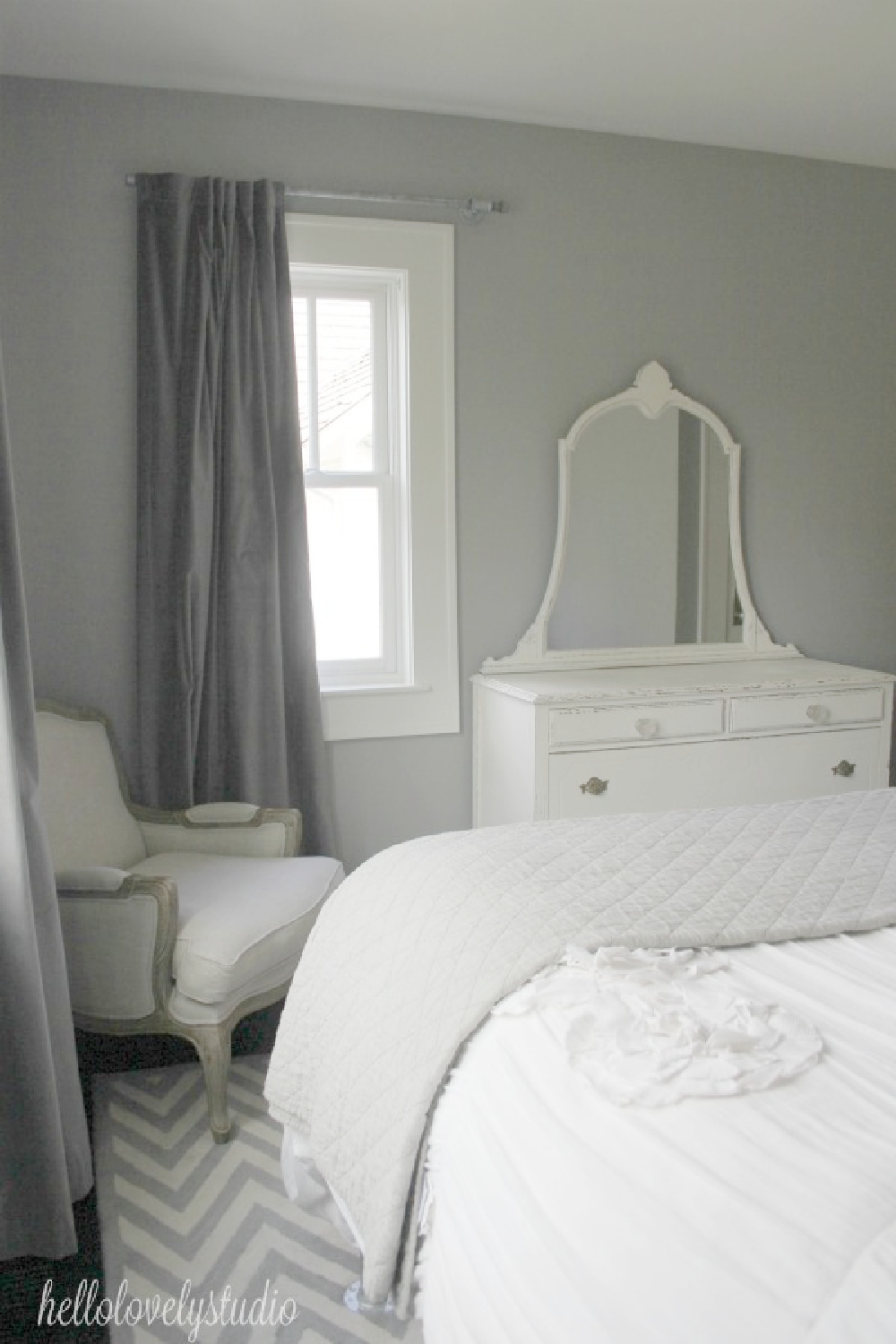 Platinum Gray (Benjamin Moore) paint color in a lovely romantic French country bedroom with white bedding and furniture. #hellolovelystudio #platinumgray #graypaintcolors