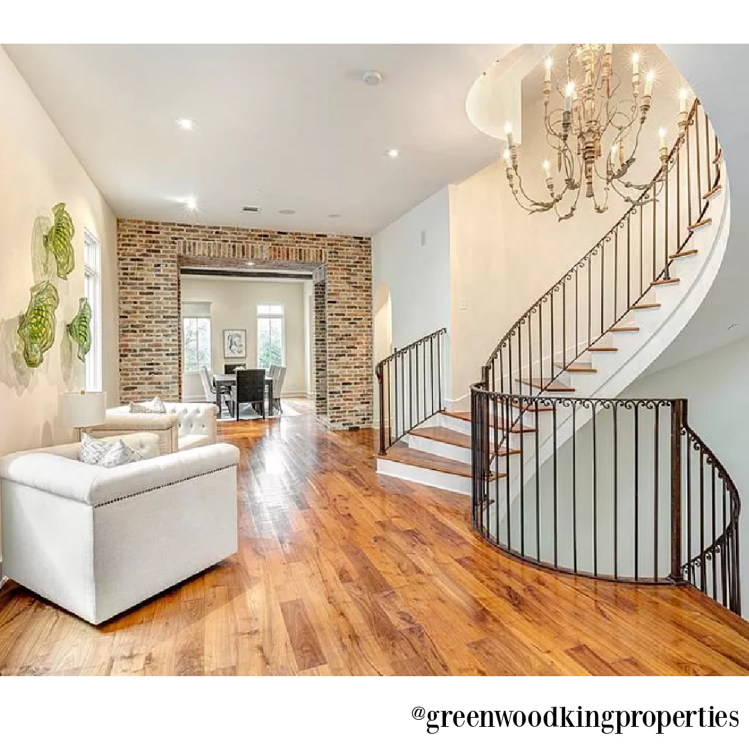 Staircase, wood floors, and chandelier in modern French Houston Home (1119 Berthea St.) - @greenwoodkingproperties. #modernfrench #interiordesign