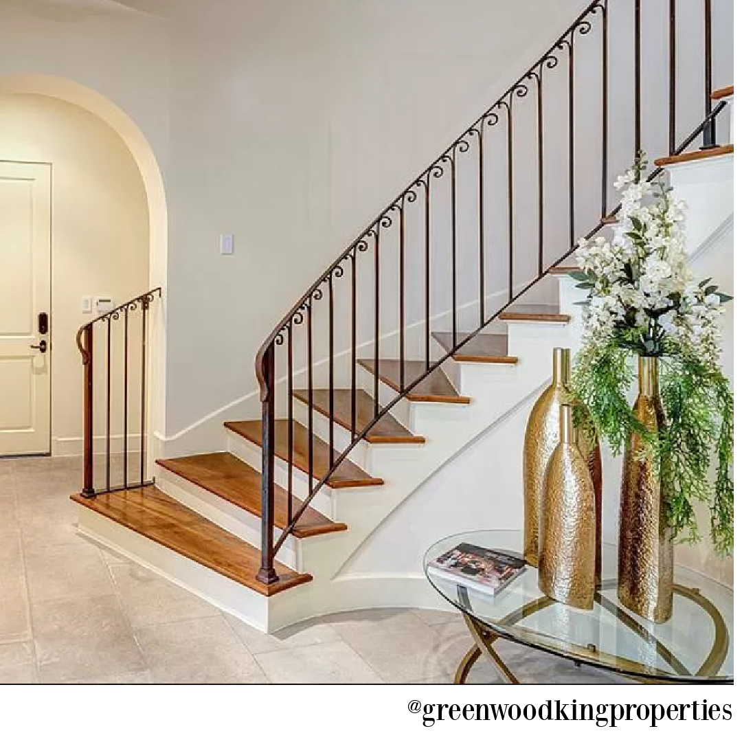 Staircase and arched doorway in modern French Houston Home (1119 Berthea St.) - @greenwoodkingproperties. #modernfrench #interiordesign