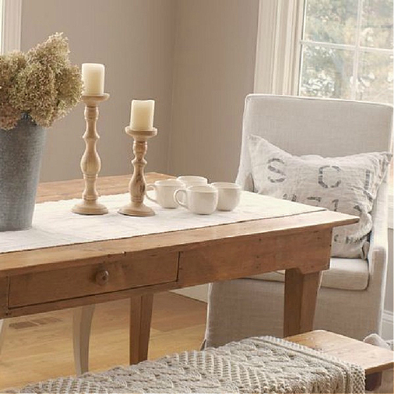 BM Ashley Gray in my serene and peaceful breakfast room with farm table and Swedish chairs - Hello Lovely Studio. #hellolovelystudio #hellolovelyhome #benjaminmooreashleygray