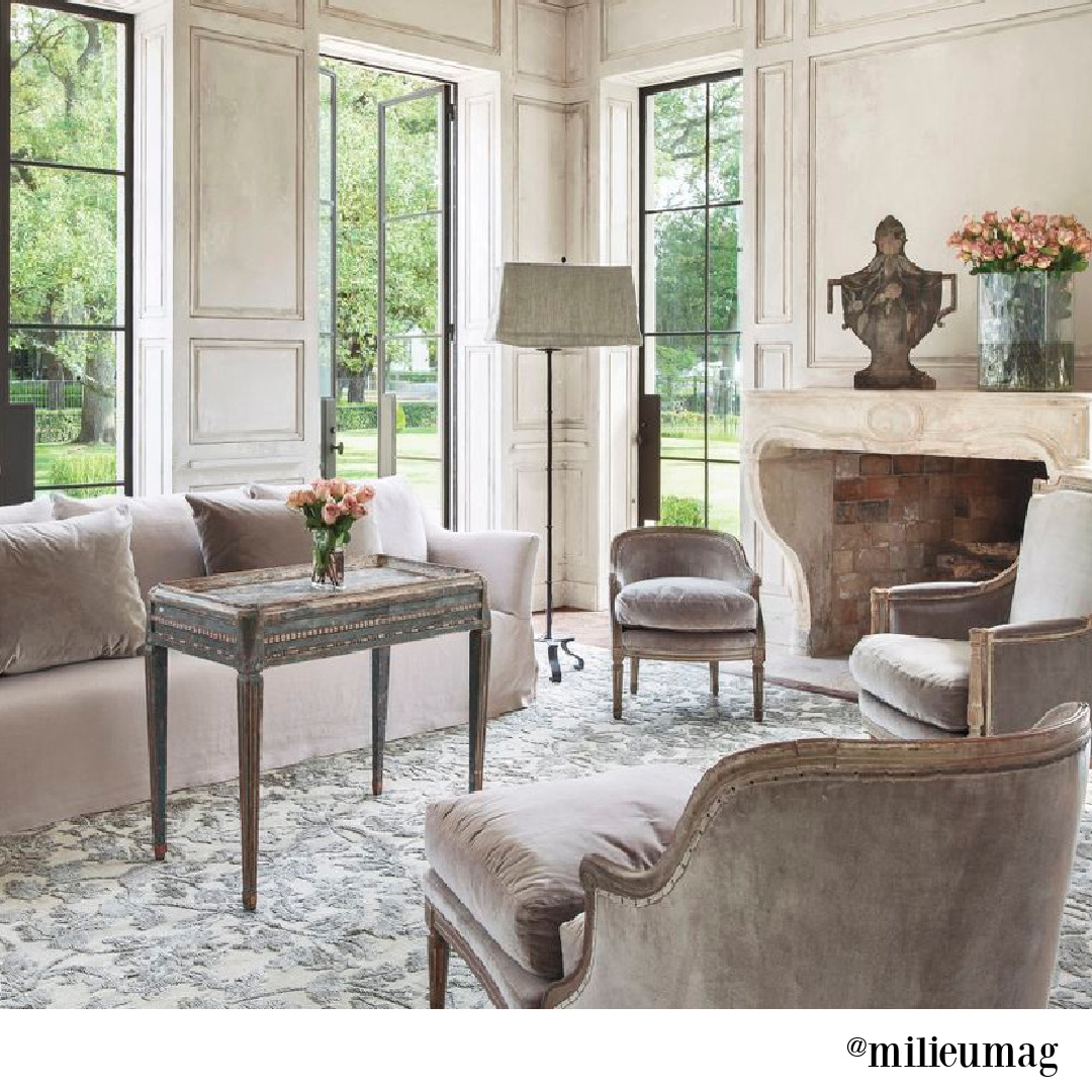 Luxurious and elegant French living room designed by Pamela Pierce with antique stone fireplace mantel and soothing serene neutrals. #interiordesign #frenchcountry #elegantdecor #pamelapierce #livingrooms