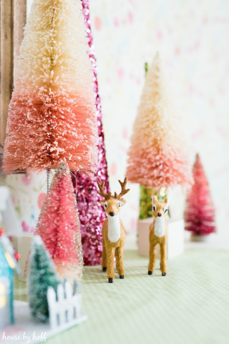 Pretty juicy pinks and cheerful blues for Christmas decor! In a girl's room, bottle brush Christmas trees and retro reindeer create a magical sweet vignette for the season. #houseofhoff #christmasdecor #bottlebrushtrees #retrochristmas #pinkchristmas #vintagestyle