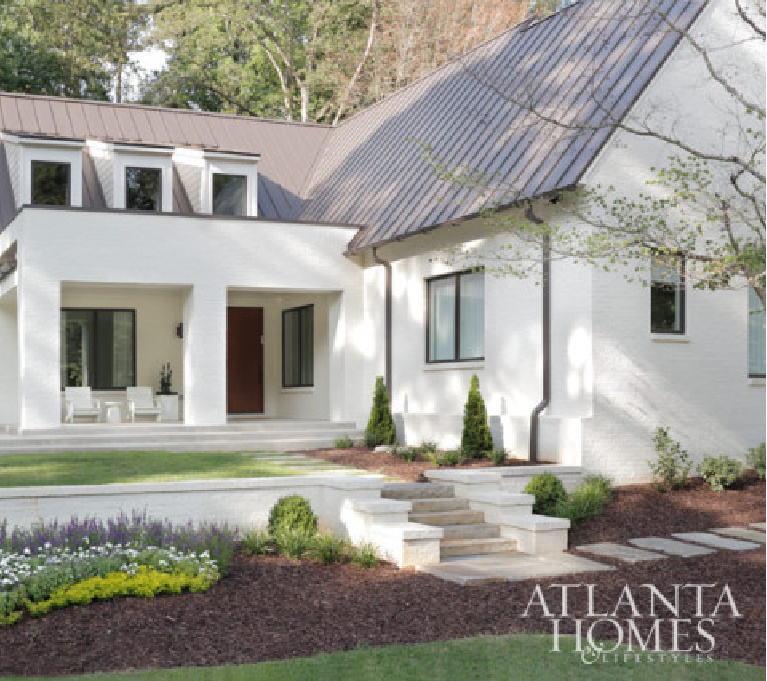 Modern farmhouse exterior painted Benjamin Moore China White - Rodolfo Castro - Atlanta Homes. #benjaminmoore #chinawhite #whitepaint #paintcolors #houseexteriors #whitehouses