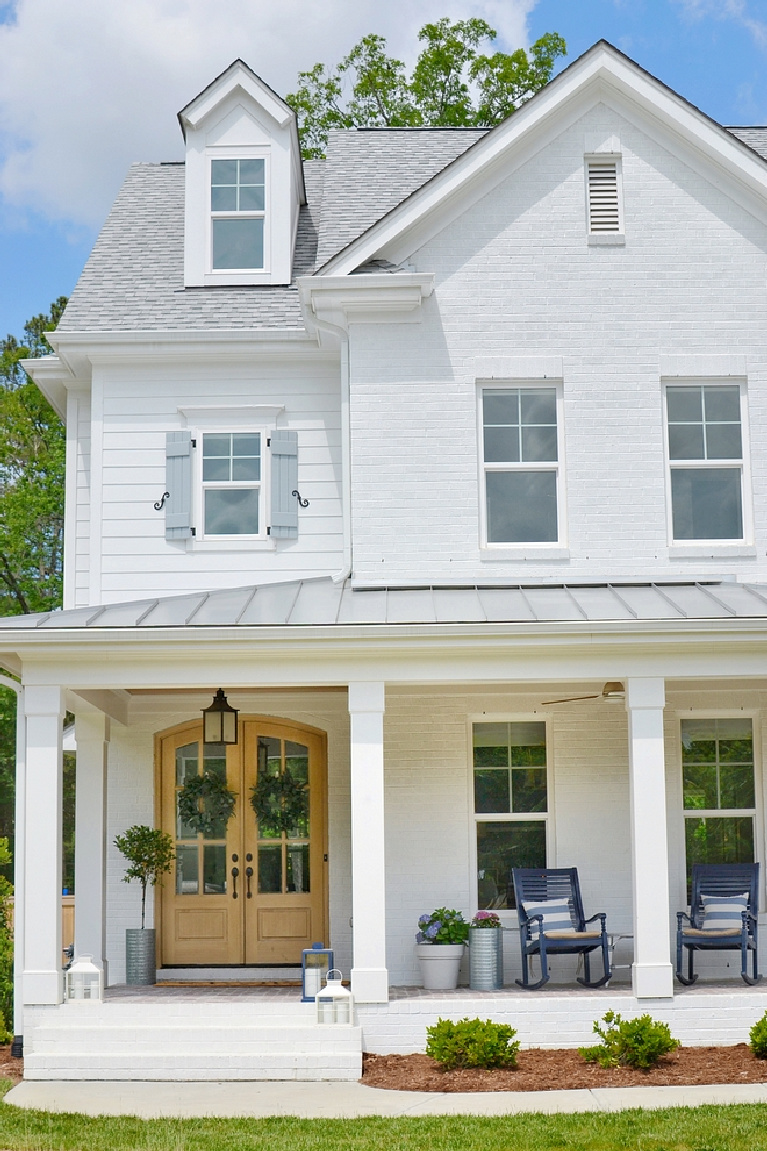 Gorgeous modern farmhouse with white brick painted Sherwin Williams Extra White - Chrissy Marie Blog. #sherwinwilliams #extrawhite #houseexterior #whitepaints #paintcolors #modernfarmhouse #exteriorcolors #housecolors