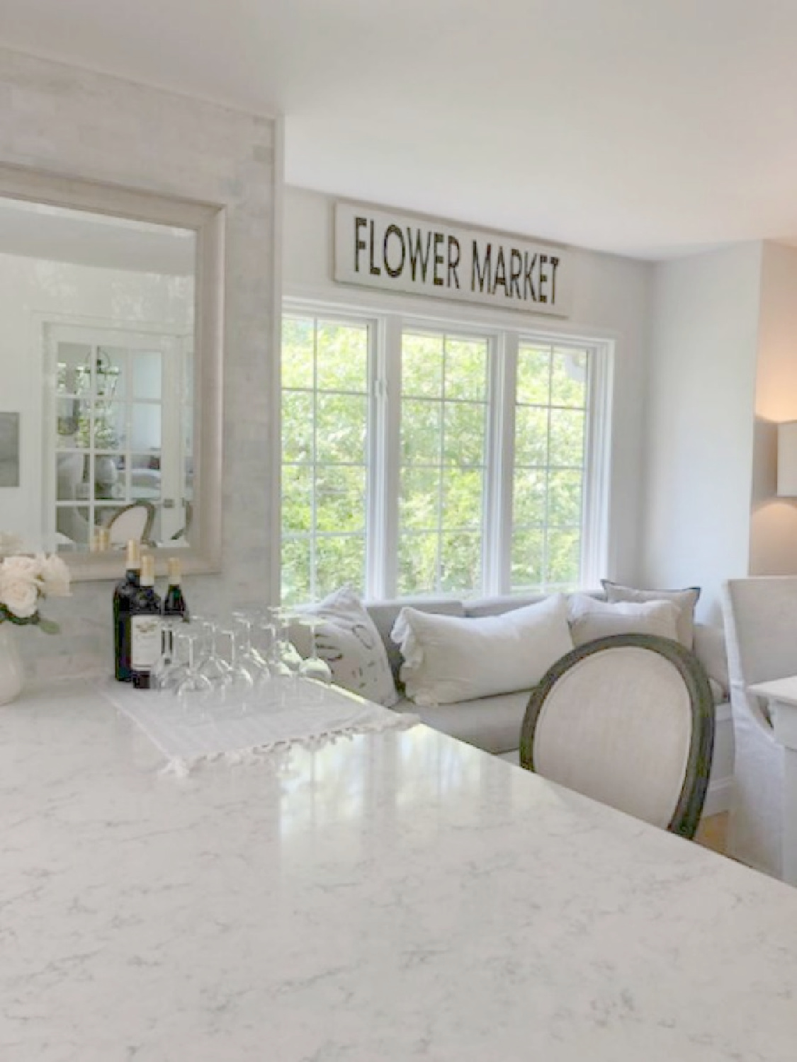 Viatera Minuet quartz counters in our serene kitchen with window seat - Hello Lovely Studio.